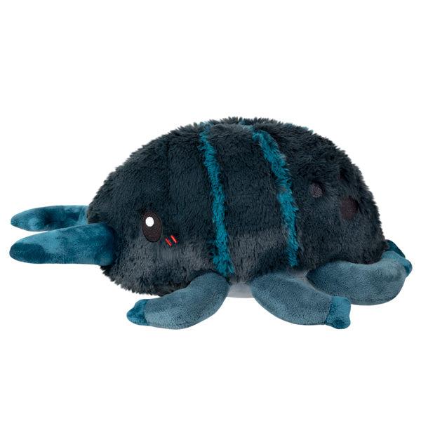 Side view of the plush. It has three legs on each side. It also has black embroidered spots on its flank.