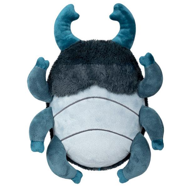 Under view of the plush. Shows that the belly is light blue with horizontal lines.