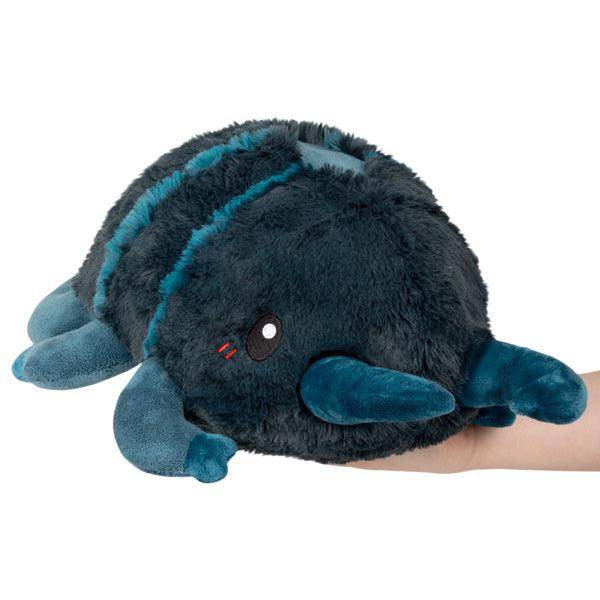 Image of the Mini Stag Beetle squishable. It is a dark green-blue with lighter blue accents. It has long pincers in the front.