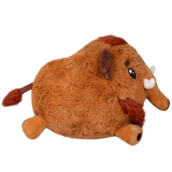 Side view of the plush. Shows that its trunk and tusks stick out from the front of its face.