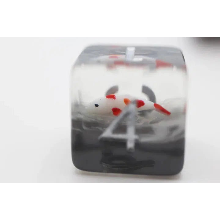 The D6 is shown alone, it's slightly cloudy grey tinted clear resin with a koi fish that's white with red spots inside of the dice.