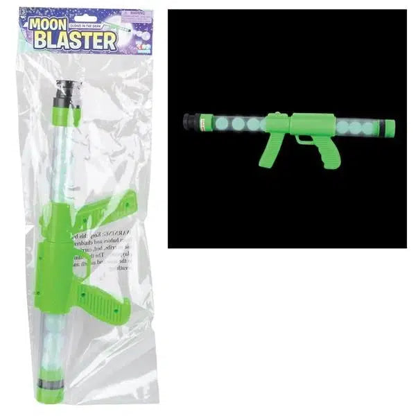 The glow moon blaster is shown in packaging on the left, it comes in a plastic bag with a cardboard name card at the top displaying the words Moon blaster. On the right the blaster is shown on a black background showing off the glowing balls. The blaster is a long clear tube full of balls with a green handle and pump handle for firing the balls.