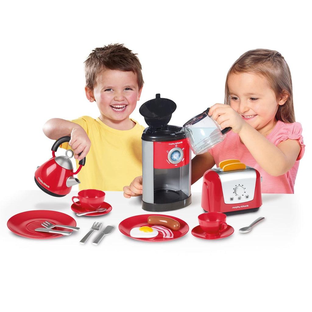 Scene of a little boy and girl using the set to make breakfast! They are both smiling and enjoying getting to learn how to cook.