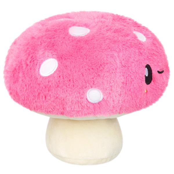 Side view of the plush. Shows that it has white embroidered spots on its head.