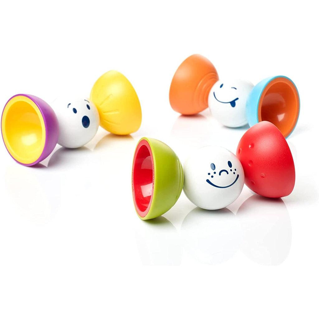 Toys out of packaging | Small white spheres with different facial expressions (surprised, happy, and winking) each sit with two other pieces magnetized to the right and left sides. | Pieces on the R/L are bowl shaped and facing open-side out. Pieces have a variety of color combos including yellow/purple, red/green, orange/blue.