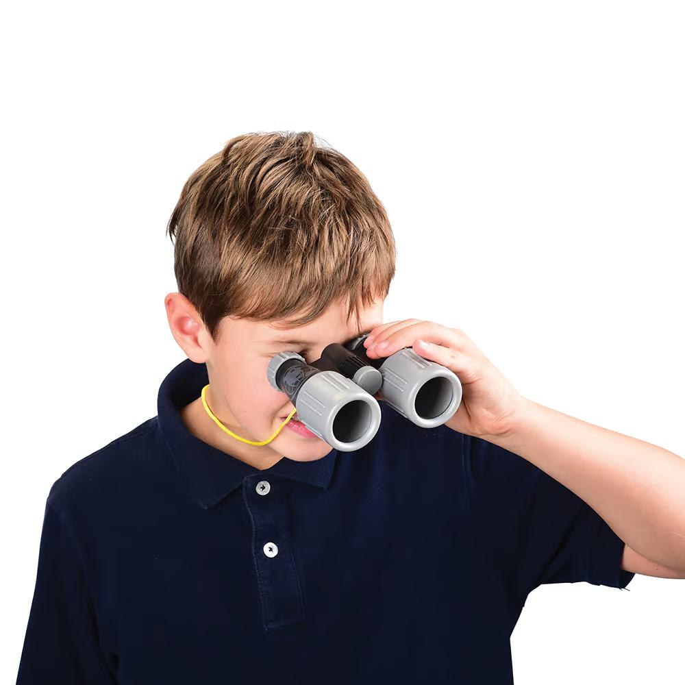 A kid is shown looking through the binoculars. The binocular neck strap is also around his neck.