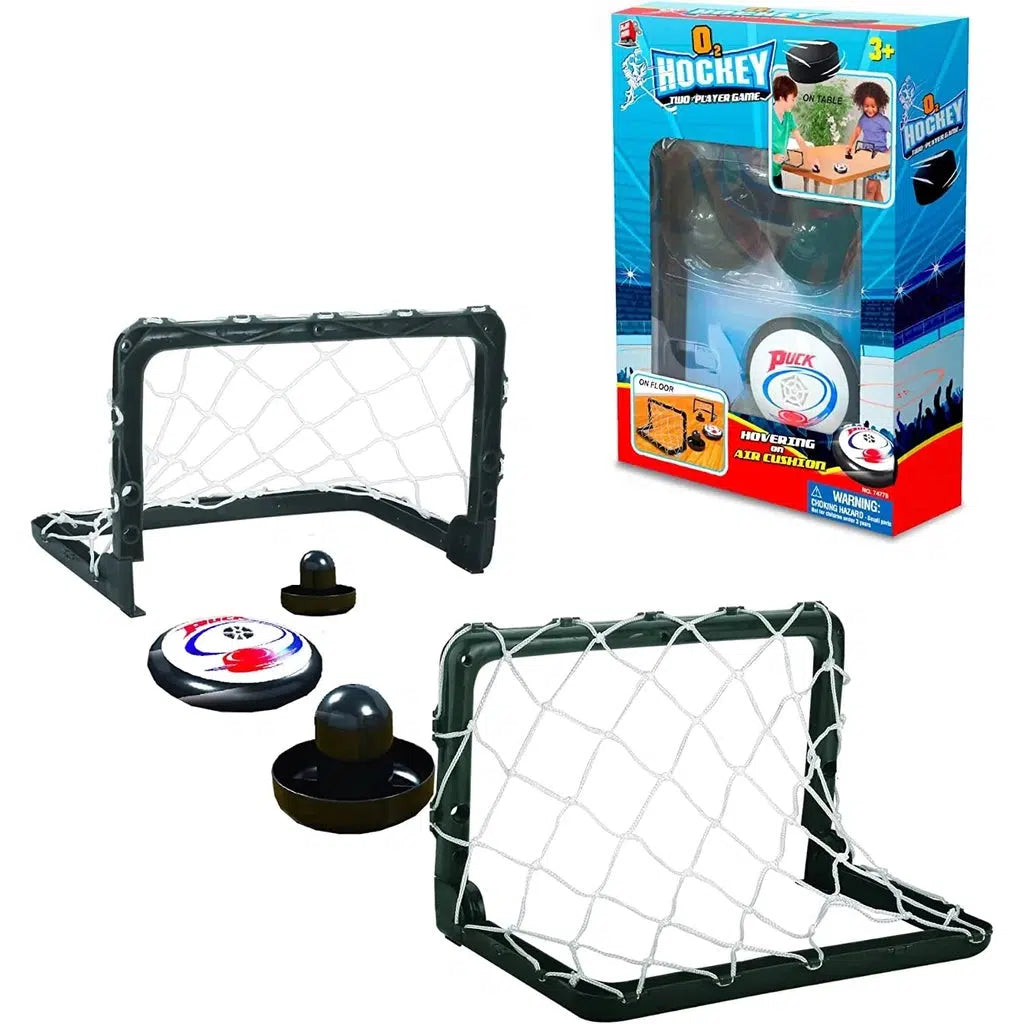 this image shows the o2 hockey box and the contents. there is a puck, two air hockey strikers and two small nets for loads of fun