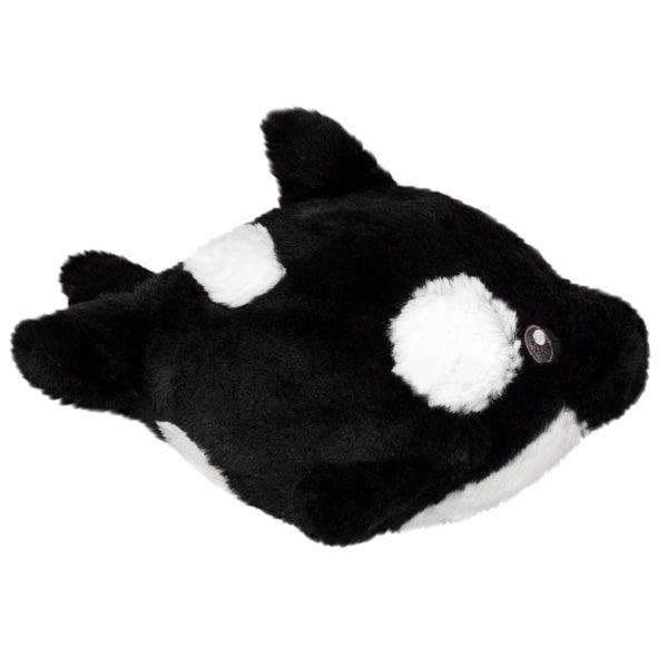 Side view of the plush. Shows that it has some white spots on the sides and back as well as the belly being entirely white.