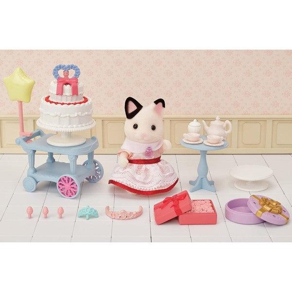 Scene of the tuxedo cat girl with all of her things waiting to eat cake and drink tea!