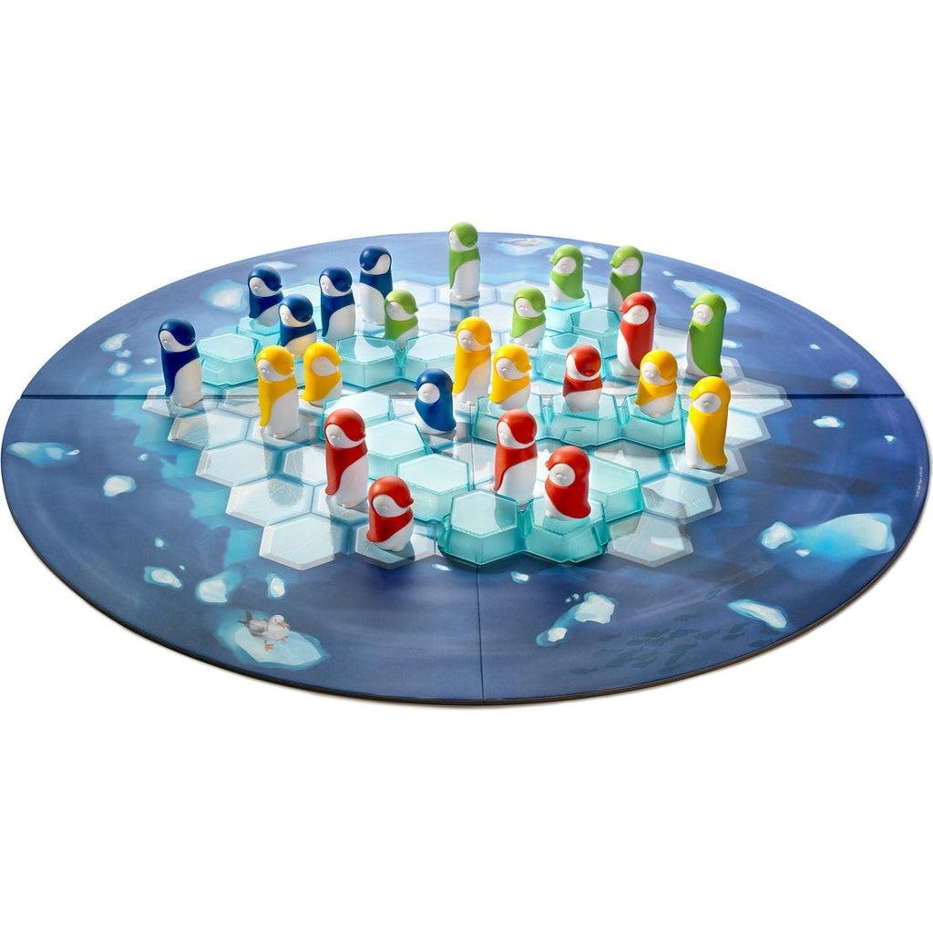 Game board is circular. Image on board consists of dark blue water surrounding an iceberg that is broken into hexagonal subsections. | Ice block game pieces are translucent, light blue, and hexagonal. They sit on top of the game board iceberg. | Blue, red, green, and yellow penguin game pieces sit within hexagonal sections of game board.