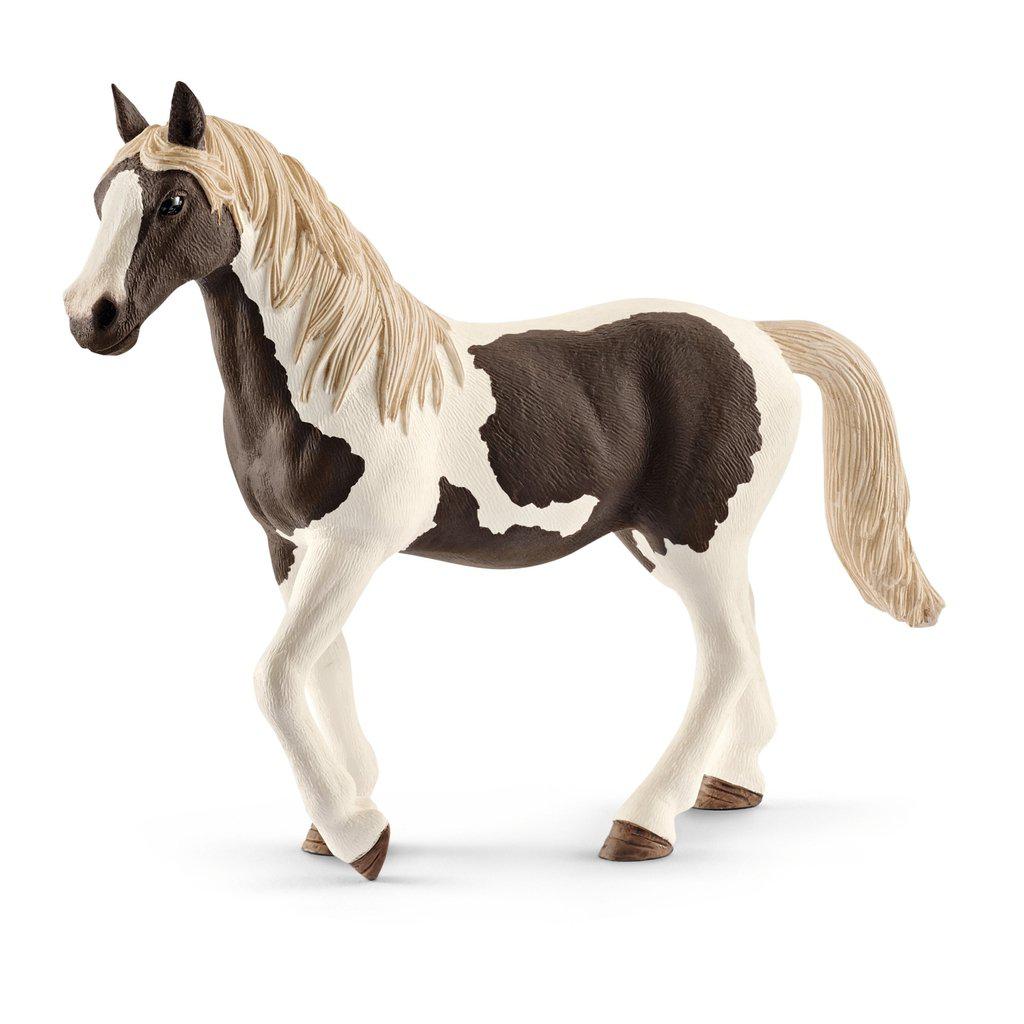 Image of the Pinto Mare figurine. It is a white pony with dark dark brown spots. Its mane and tail are blonde.