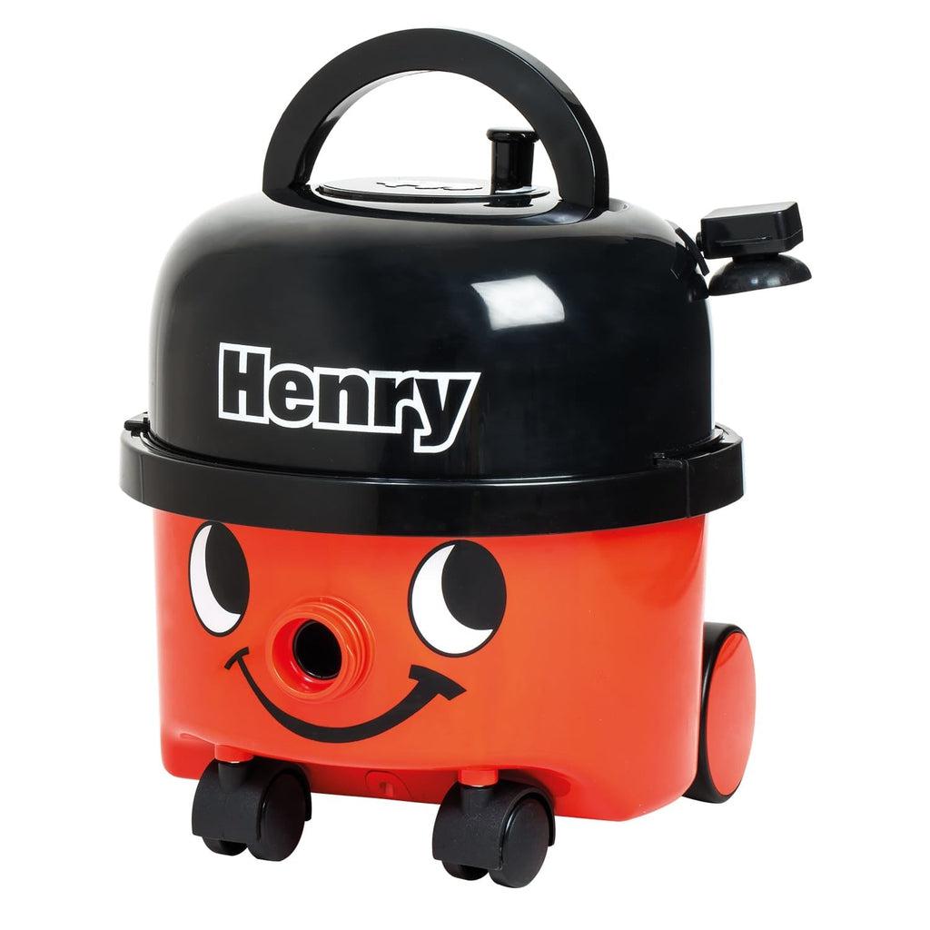 Image of the Play Henry Vacuum Cleaner. It is red and black colored and on the front is has a smiling face. The nose of the face is where the vacuum hose attaches. It has wheels so that it can roll with you as you clean.