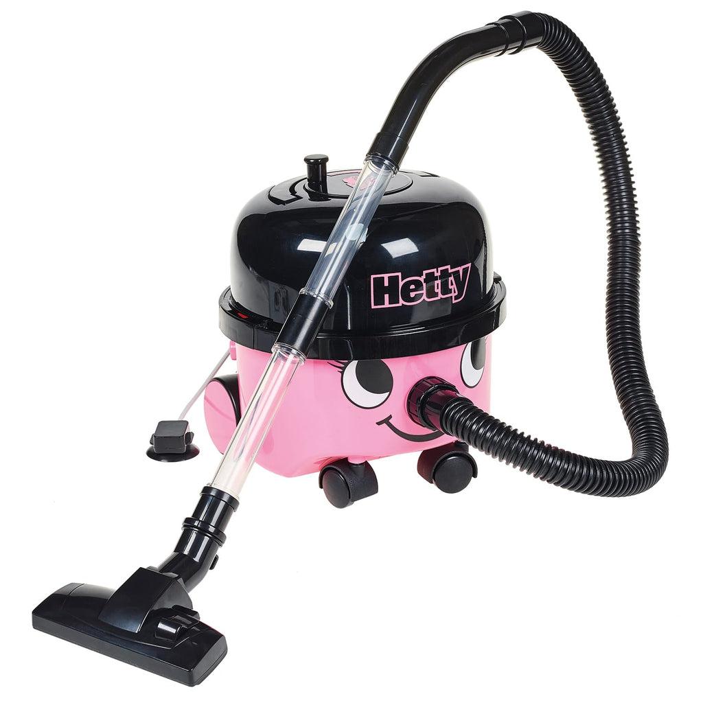 Image of the Play Hetty Vacuum Cleaner. It is black and pink colored with a face on the front. The nose is where the vacuum hose attaches to. It has wheels so it can move with you as you clean!