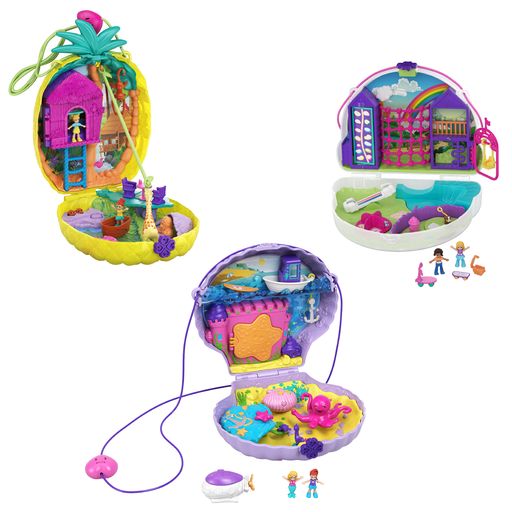 Three of the items in the assortment are shown. One is shaped like a pineapple that opens to reveal a treehouse, one shaped like a clam opens to reveal an underwater castle, and one shaped like a cloud reveals a playground in the sky.