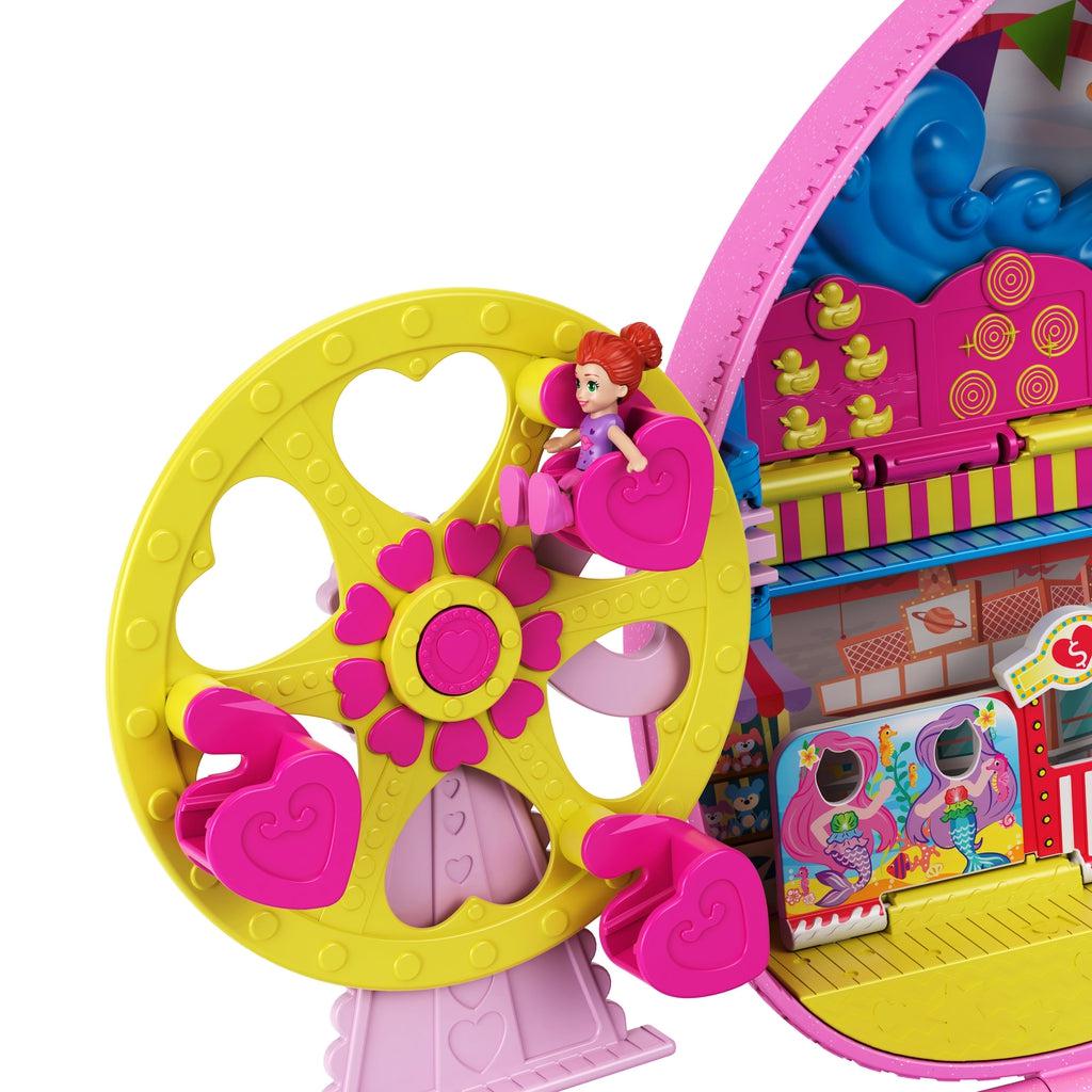 Close-up of Ferris wheel | Lila sits in a heart shaped seat on the pink and yellow heart themed Ferris wheel.