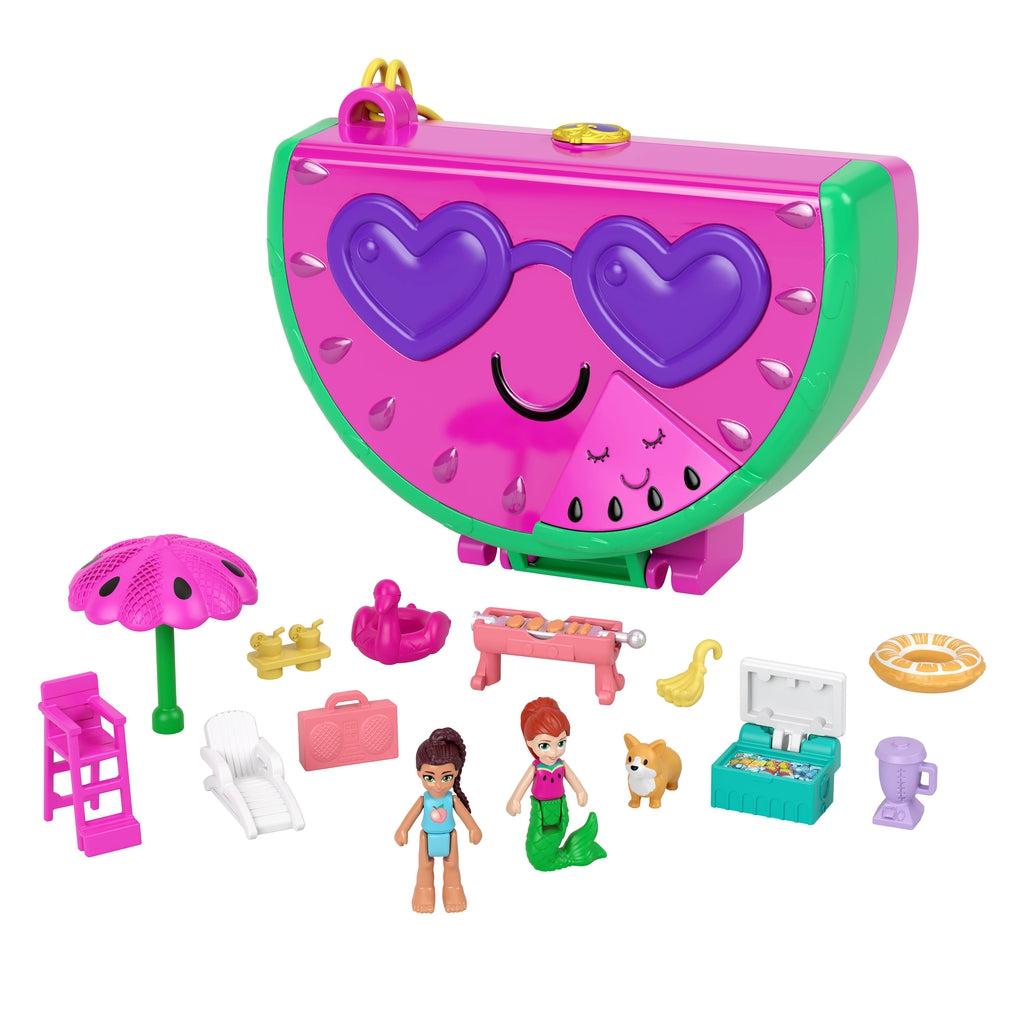 Image of the case and many of the included pieces outside of the packaging. The carrying case/play set is a hot pink watermelon with sun glasses.