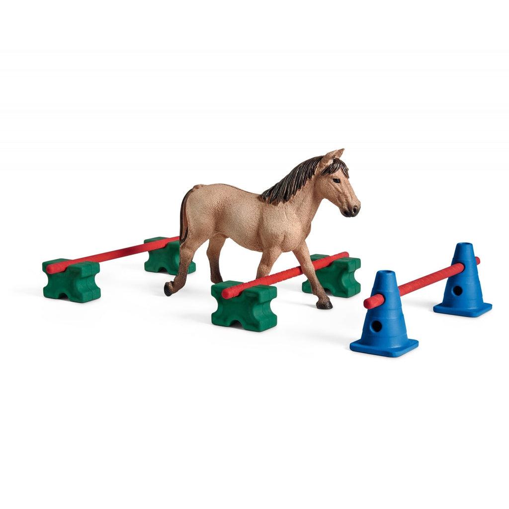 Image of all the included pieces outside of the box. The set includes a tan and brown horse and three different hurdles or varying heights.