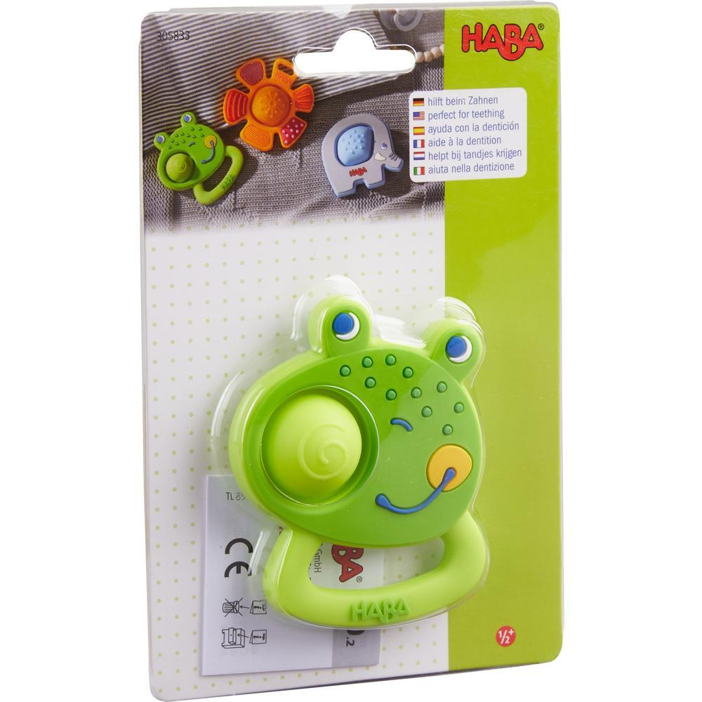 Image of the packaging for the Popping Frog Teether. Part of the front is made from clear plastic so you can see the toy inside.