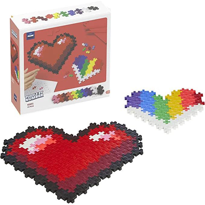 Plus Plus Puzzle by Number Hearts in packaging. Image: One red and one rainbow heart made of Plus Plus toy pieces | Puzzles can be seen outside of packaging