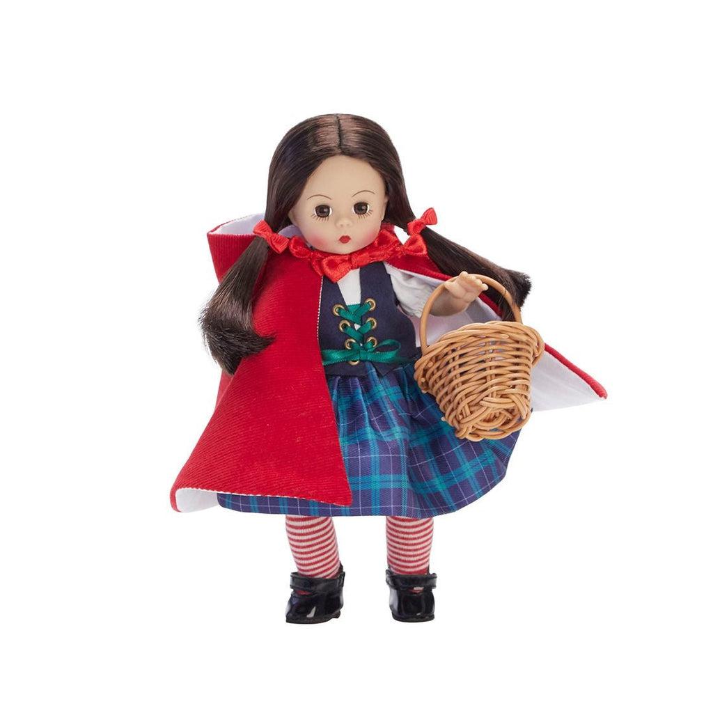 The doll has waist length brown hair in two pigtails, it's wearing a red cloak with a big hood, holding a whicker basket, and wearing red/white striped tights, a blue/purple plaid skirt and a vest tied in the front