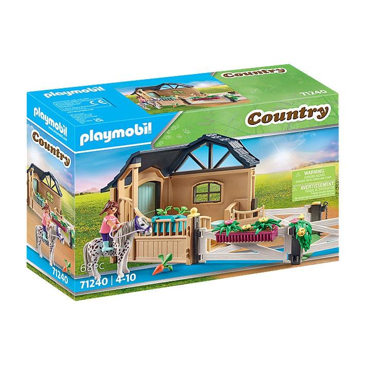 The front of the box shows the little girl playmobil figure riding a white horse with brown spots outside the stable extension building