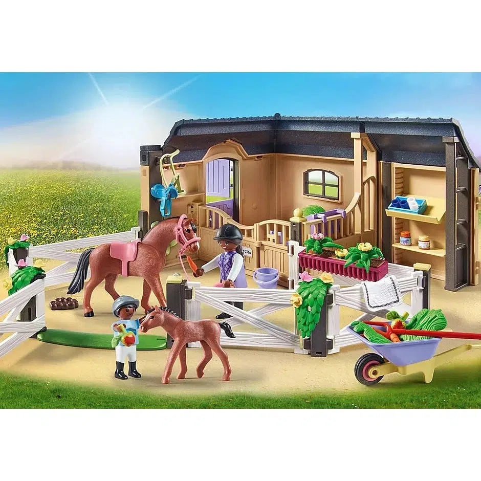 The image from the front of the box is shown. The two figures are caring for the horses at the paddock