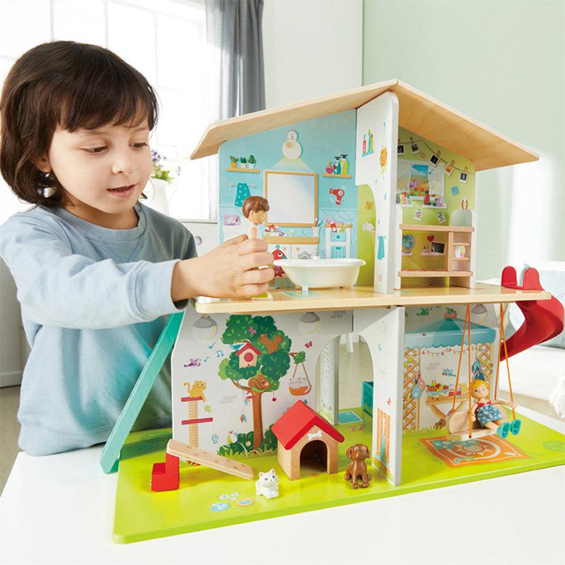 a small child is shown playing with the dollhouse