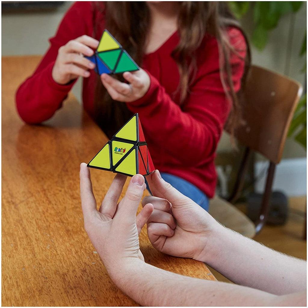 Scene of two older kids trying to solve their Rubik's Pyramids.