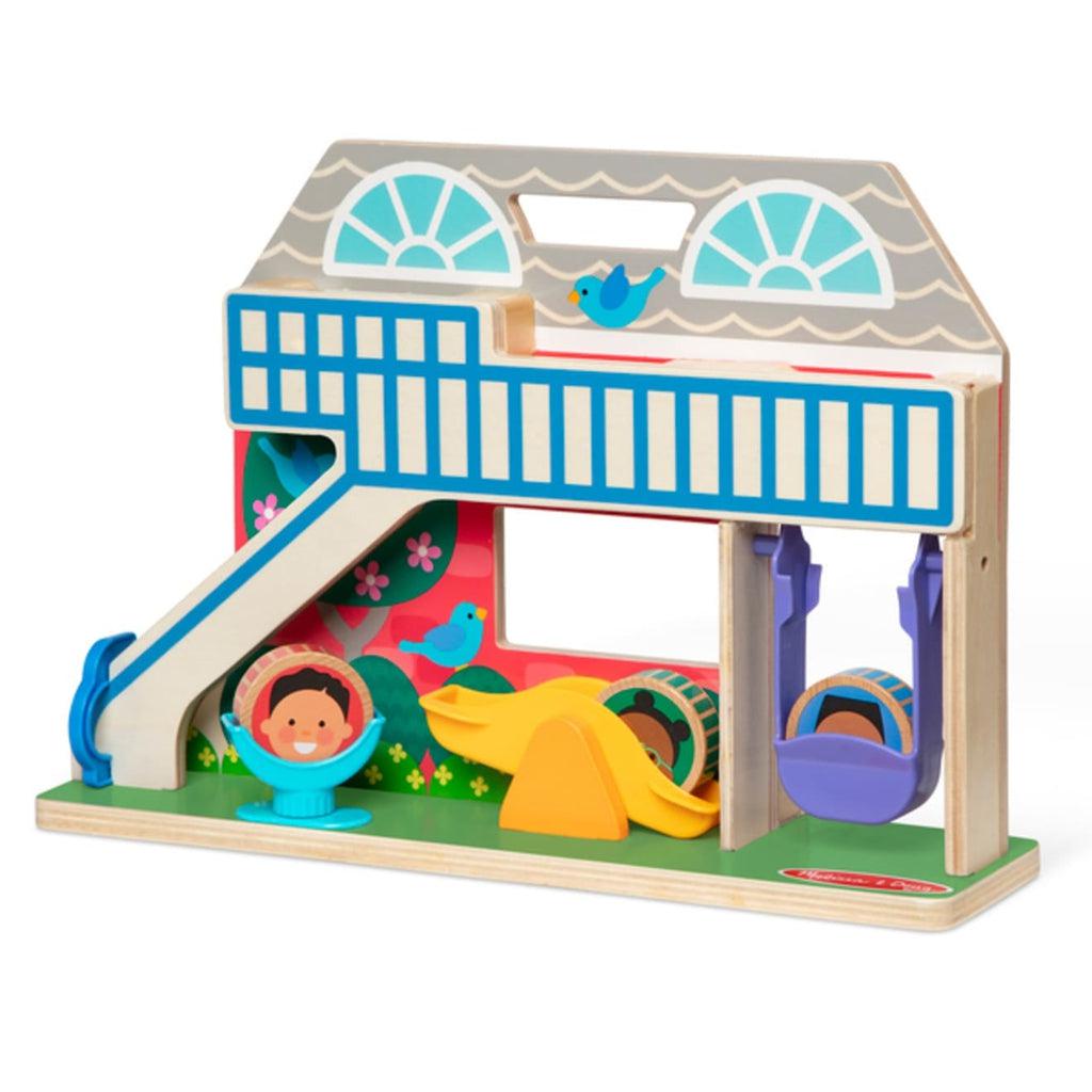 Toy out of packaging | Toy is 2D a double sided wooden school and playground | Playground side includes 3D slide, swing, seesaw, and spinning seat | Wooden disks with cartoon children's faces fit into 3D portions of playground