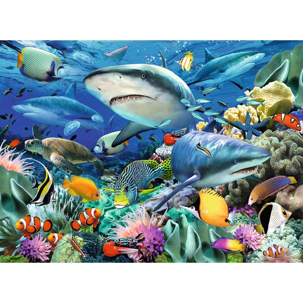 Puzzle image | 4 sharks swim above a coral reef teeming with tropical fish and coral. A turtle and jellyfish surround the sharks.