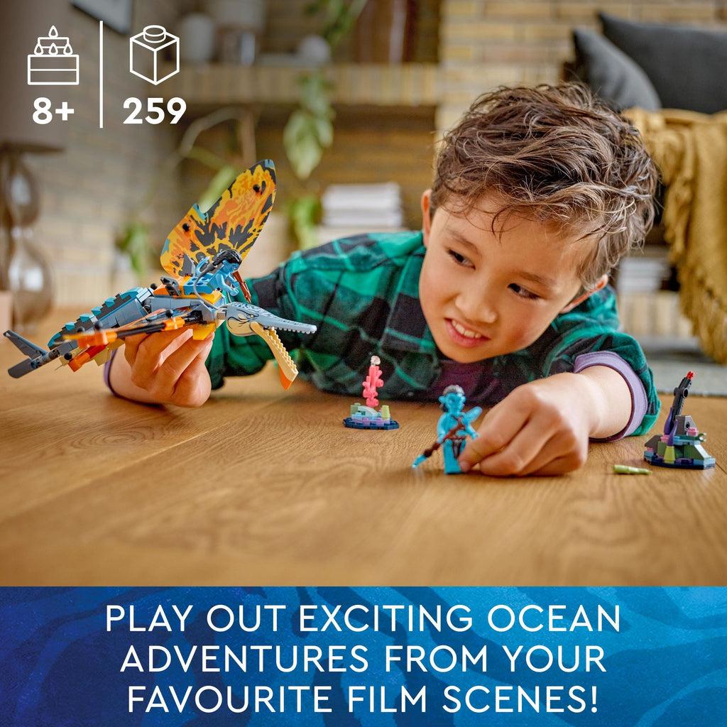 A boy is playing with the lego set | Image reads: play out exciting ocean adventures from your favorite film scenes