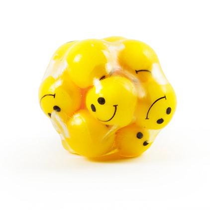 The stress ball is a clear rubber ball full of smaller yellow rubber balls with smiley faces on them.
