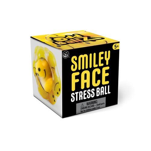 The packaging reads: Smiley Face Stress Ball 5+. The left side of the box has a cutout showing the stress ball inside.