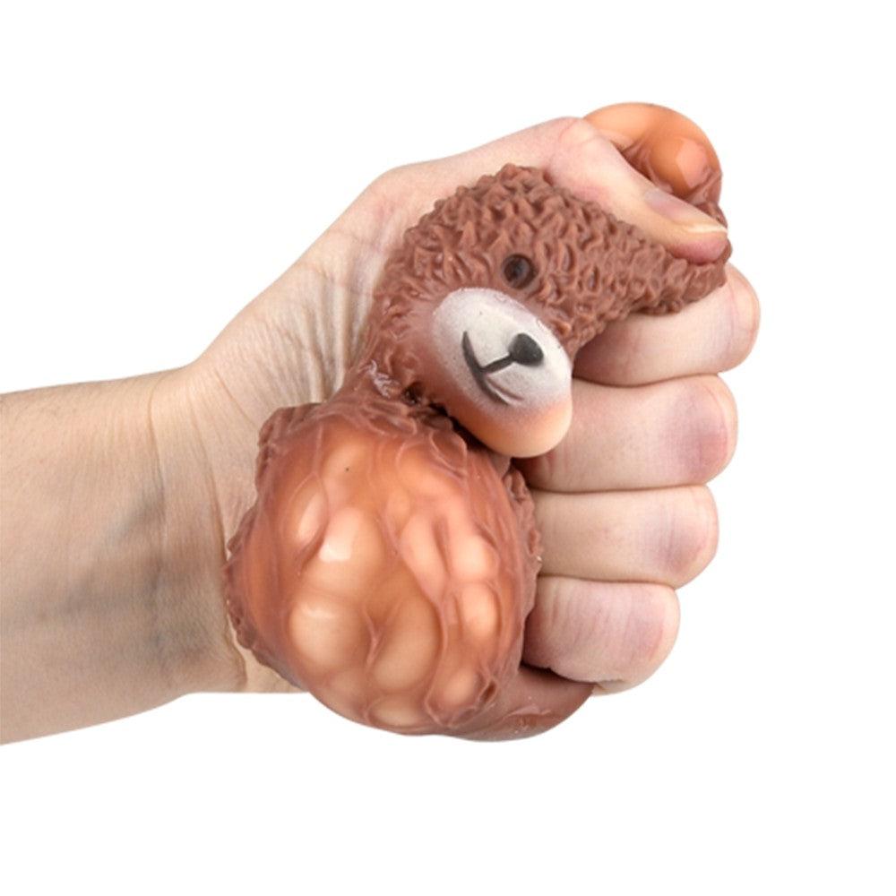 Shows the hand squeezing the toy.