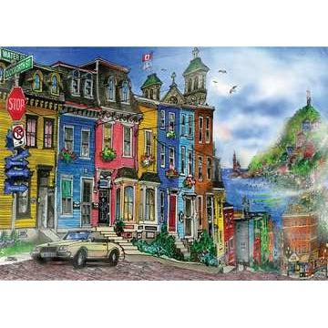 Image of puzzle | Street view of colorful townhomes in St. John. A car is parked on the street and the sea is visible in the distance.
