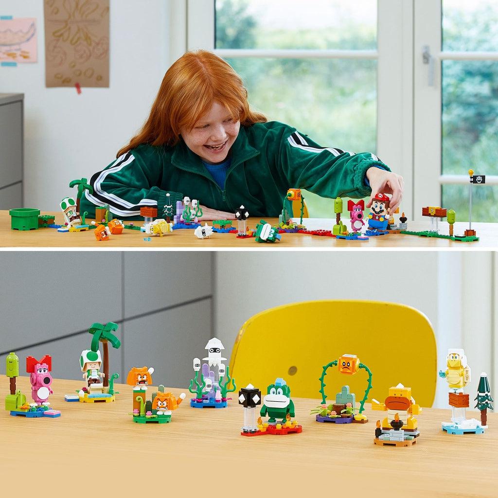 a child is shwon using the lego mario figure (not included) to interact with each of the possible characters from this mystery box