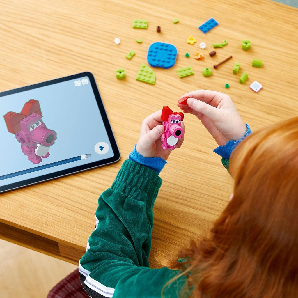 a child uses the lego builder app for instructions on how to put together the birdo lego characters