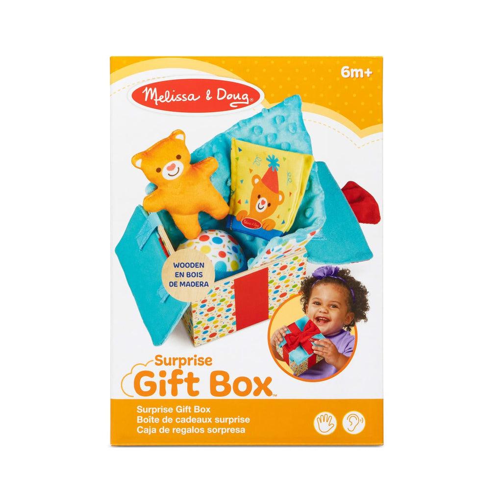 Surprise Gift Box inside package | Image on package shows wooden box open with contents inside | Additional image shows infant holding closed gift box
