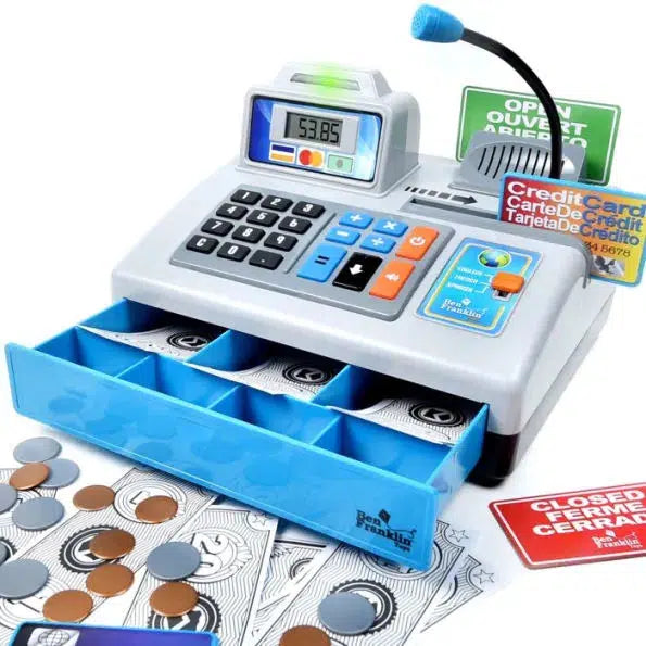 Image of the play register outside of the packaging. It is mainly colors of grey with some blue accents. It has a digital display, buttons, a cash drawer, credit cards, and fake bills and coins.