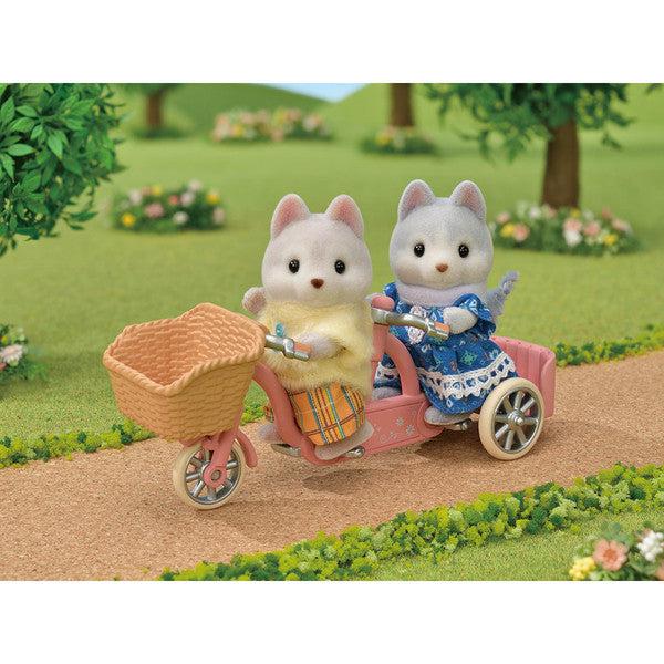 Scene of the brother and sister riding the bicycle in the forest.