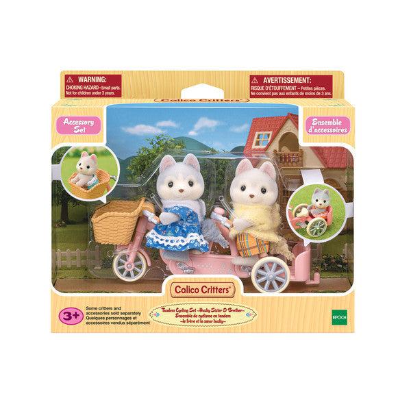 Image of the packaging for the Husky Sister & Brother Tandem Cycling Set. The front is made of clear plastic so that you can see all the included pieces to the set.