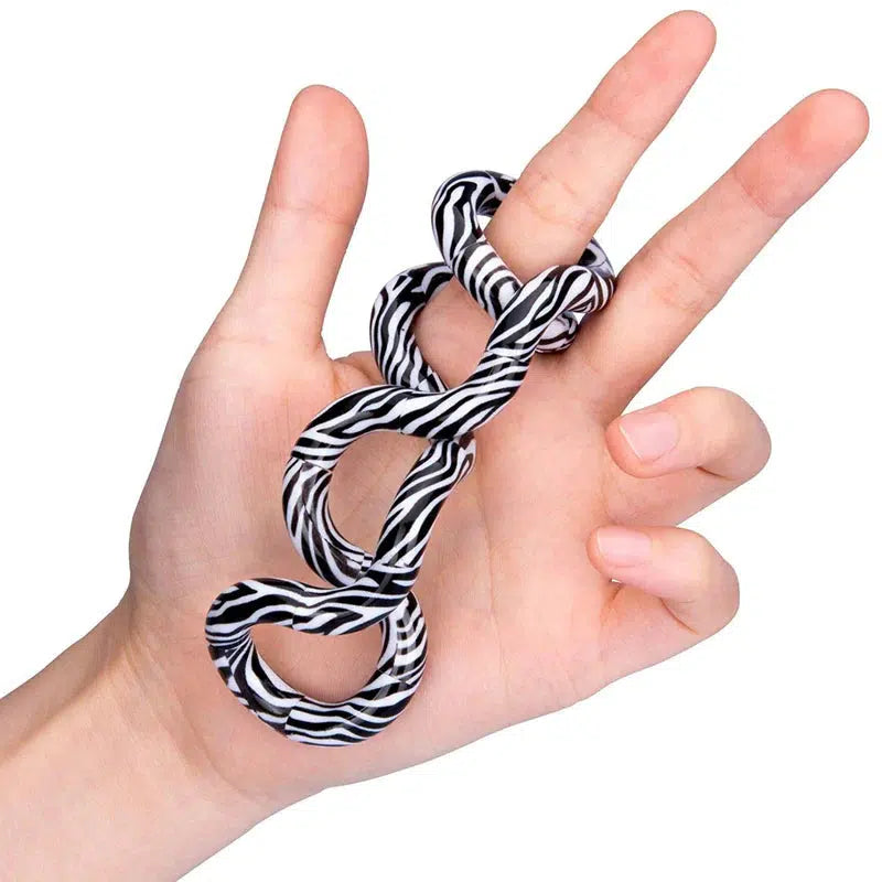 A zebra striped tangle is lopped twice around a persons pointer finger and the rest of the tangle loops around in their palm.