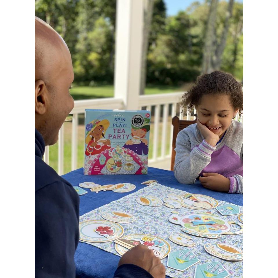 a dad and daughter are plating the spin to play tea party game! fun for the family. 