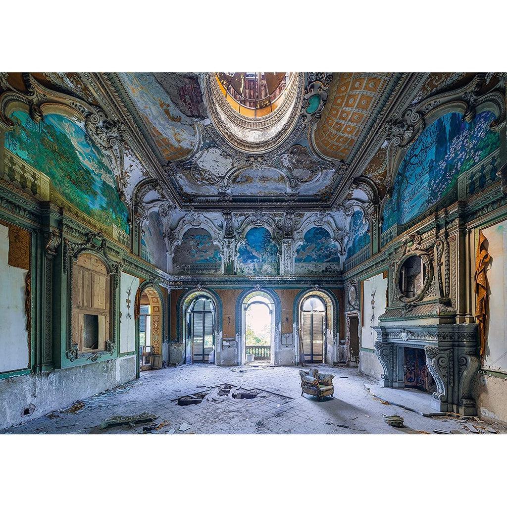 Puzzle image | View of an abandoned ballroom | Intricate ceiling paintings and molding are chipped and flaking | An ornate fireplace sits against the right wall | The floors, walls, and doorways have been damaged | Light streams in through a single open door.