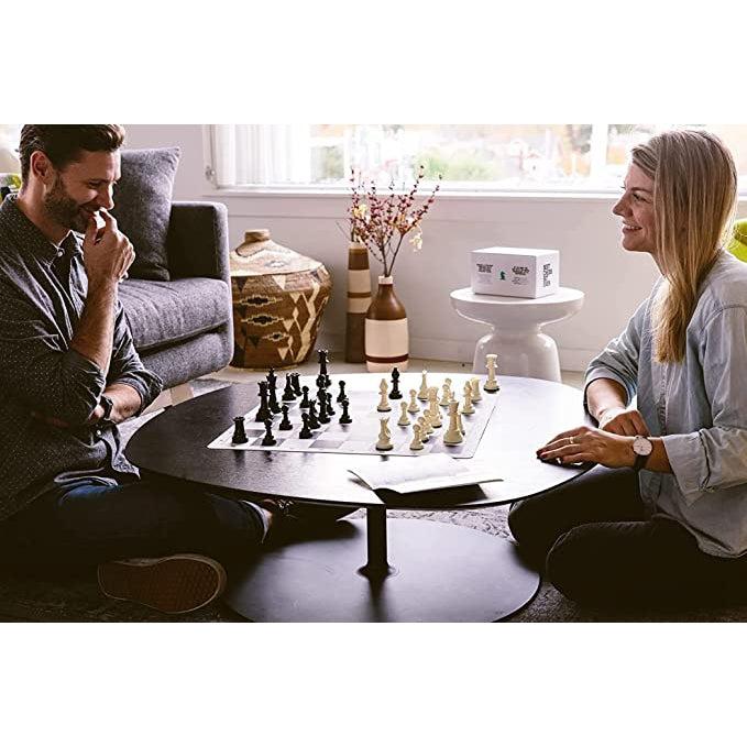 Couple playing chess with the chess set.