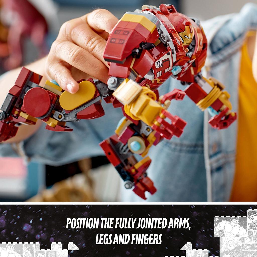 a childs hand hold the hulkbuster in the air, it's arms are positioned forwards and its legs are in a one leg kneeling position | image reads: Position the fully jointed arms, legs, and fingers