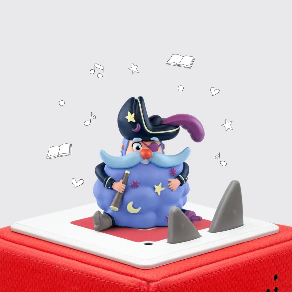 Dreambeard tonie on a red toniebox | tonie is a pirate with a big hat, a purple peg leg, eyepatch, and feather, a blue mustache and eyebrows, and a beard that's a giant dark blue cloud with stars and a moon shape on it.
