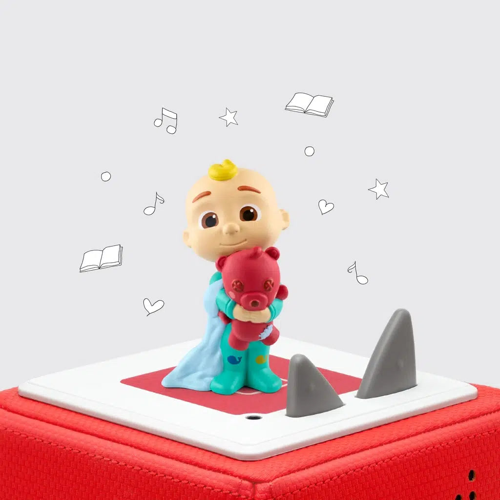 Tonie figure on a red tonie box | figure is a toddler with a tuft of blond hair, wearing teal pajamas with whales on them, holding a red bear, and holding a light blue blanket