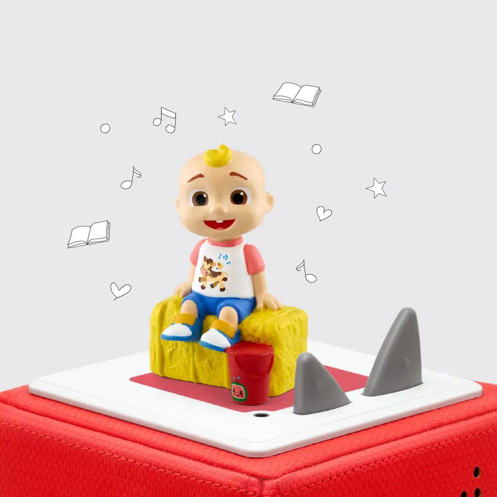 JJ tonie shown on a toniebox | tonie is a toddler with tuft of blond hair sitting on a hay bale with a  red bucket by his feet