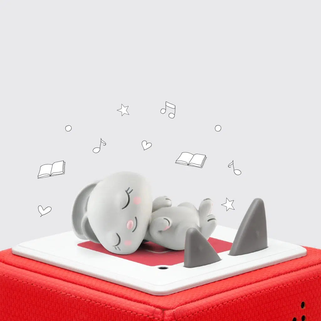 The tonie figure is a light gray cartoonish rabbit sleeping on it's back with it's head to the side and paws in the air. It's shown on top of a red toniebox